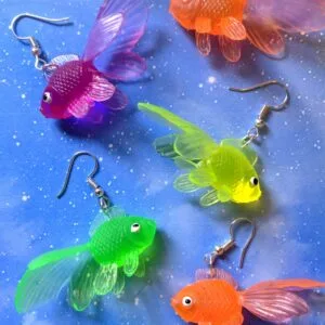 Our multicolour goldfish earrings are scattered against a blue backdrop