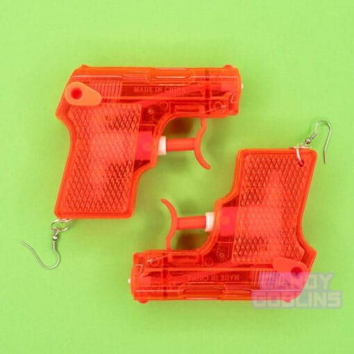 A red pair of water pistol earrings