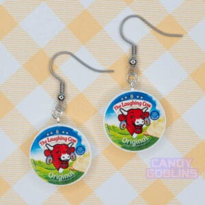 A pair of laughing cow earrings, featuring the laughing cow herself