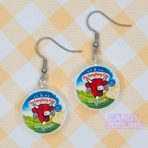 A pair of laughing cow earrings, featuring the laughing cow herself