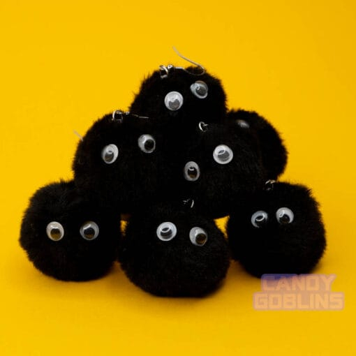 Black soot sprite earrings are stacked up in a big pile. The googly eyes on the sprites stand out like they're looking at you.