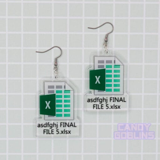 A pair of our Excel Earrings are laid out against a green backdrop. They feature the Microsoft Excel logo, with text underneath that reads "asdfghj FINAL FILE 5.xlsx"