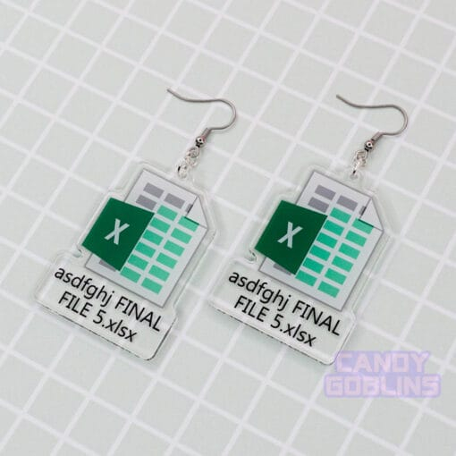 A pair of our Excel Earrings are laid out against a green backdrop. They feature the Microsoft Excel logo, with text underneath that reads "asdfghj FINAL FILE 5.xlsx"