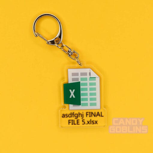 A photo of our Excel Keychain. The background is yellow. The keychain features the Microsoft Excel logo, with text underneath that reads "asdfghj FINAL FILE 5.xlsx"