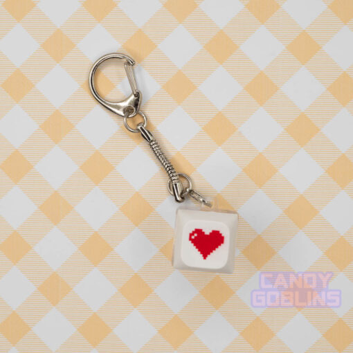 A white Keyboard Switch Keychain with a red heart