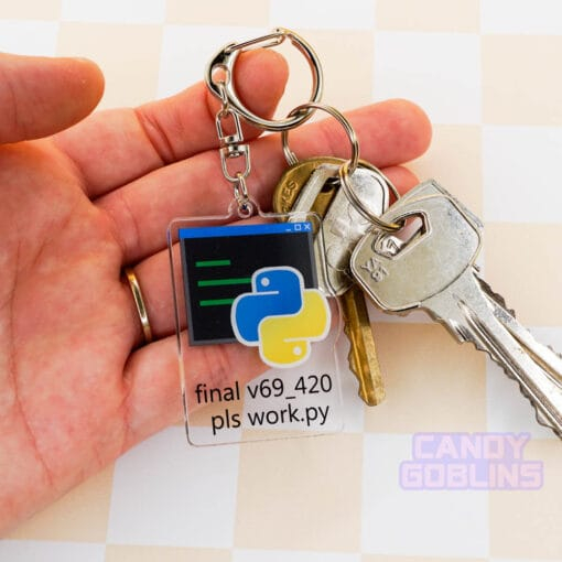 A hand holds our Python keychain that is attached to a set of keys. The keychain features the Python logo, with text underneath that reads "final v69_420 pls work.py".