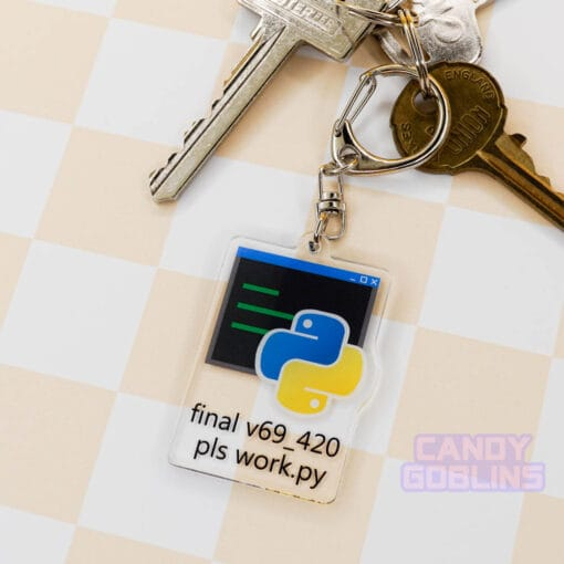 Our Python keychain is attached to a set of keys that is laid out against a pastel yellow backdrop. The keychain features the Python logo, with text underneath that reads "final v69_420 pls work.py".