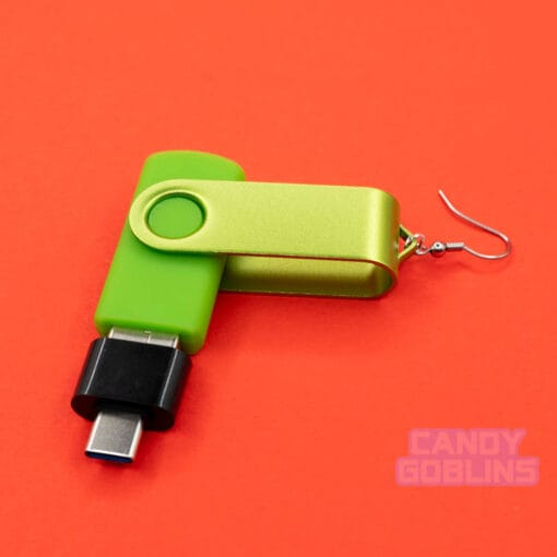 A single USB stick earring, that is bright green with a USB-C adapter plugged into the end.