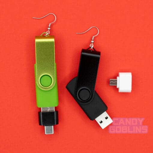 A pair of USB stick earrings, one USB is black, the other is a bright green. The micro USB and USB-C adapters are shown off as well.