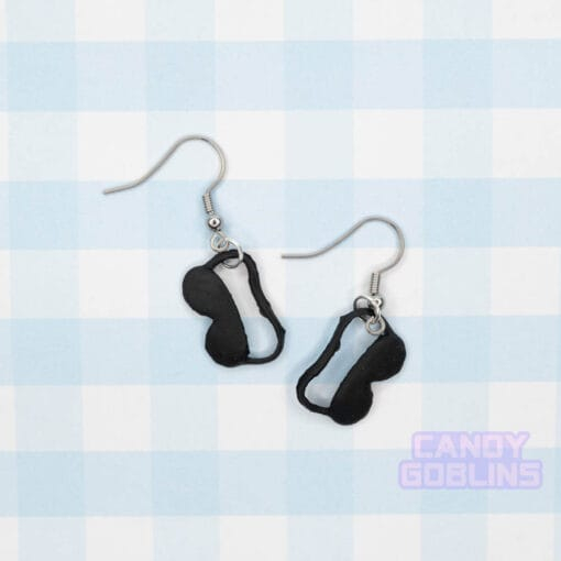 A pair of black eye mask earrings