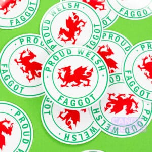 Stickers are scattered across a green background. The stickers have Welsh dragons on them, and text around it reads 