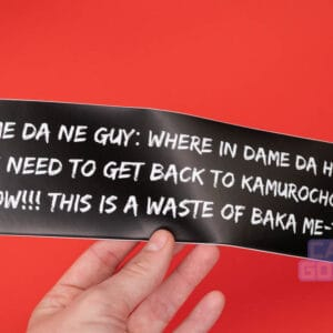 Someone holds one of our Yakuza bumper stickers