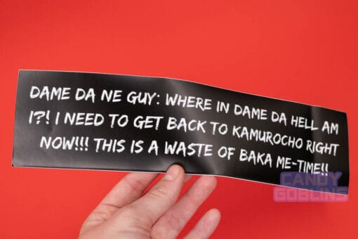Someone holds one of our Yakuza bumper stickers