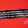 A black bumper sticker shown against a red background. The sticker reads: DAME DA NE GUY: WHERE IN DAME DA HELL AM I?! I NEED TO GET BACK TO KAMUROCHO RIGHT NOW!!! THIS IS A WASTE OF BAKA ME-TIME!!