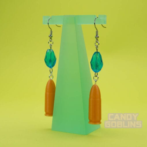 A pair of our Revolver Earrings hang from a photo prop