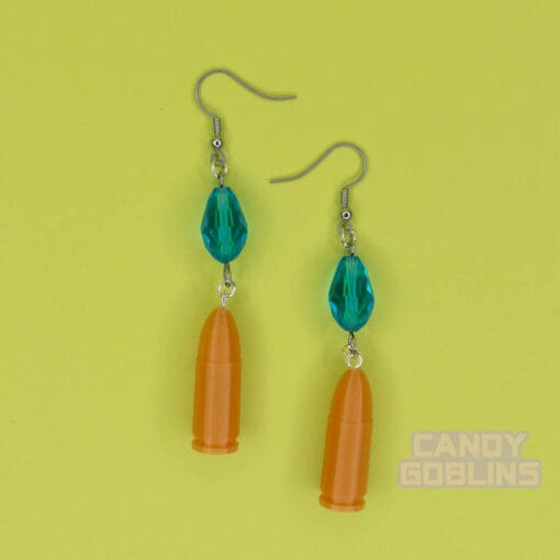 A pair of our Revolver Earrings. clearly photographed so you can see the blue beads, and gold bullets