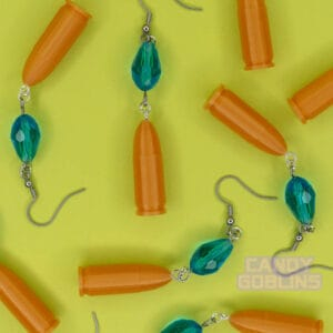 Our Revolver Earrings are scattered across a photo backdrop