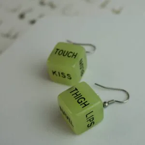 A pair of our glow in the dark sex dice earrings. They say the words 